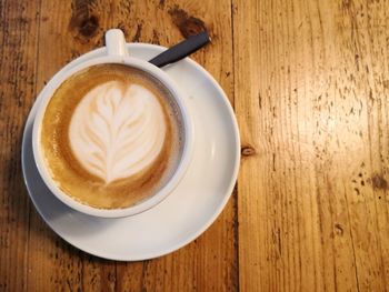 Directly above shot of cappuccino served on table