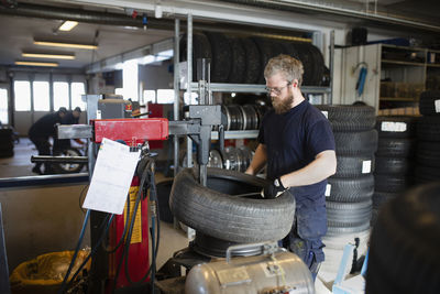 Mechanic in garage changing tire