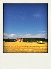 Scenic view of field against cloudy sky