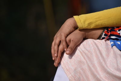 Close-up of couple holding hands