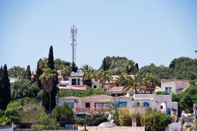 Buildings in town against clear blue sky