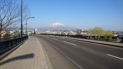 Empty road leading towards mountains