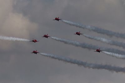 Low angle view of airshow against sky