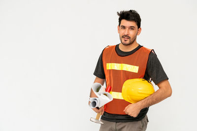 Portrait of smiling man standing against white background