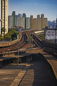 Railroad tracks amidst buildings in city against sky -sao paulo -bresser-mooca station