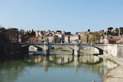 Bridge over river with buildings in background