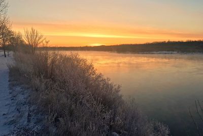 Scenic view of lake against sky during sunset