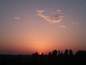 Silhouette trees against sky during sunset