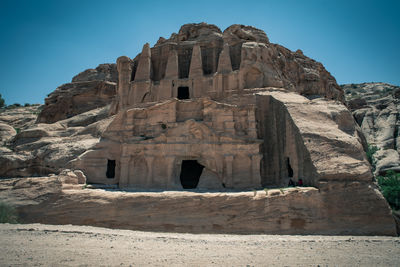 Low angle view of rock formation against clear sky