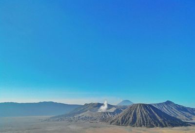 Scenic view of mountains against clear blue sky