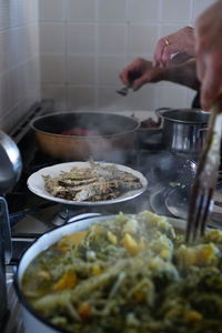 Midsection of person preparing food in kitchen