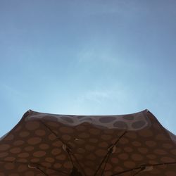 Low angle view of wall against clear blue sky