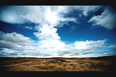 Scenic view of landscape against cloudy sky