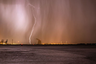 Lightning bolt strikes next to a nuclear power plant during a severe thunderstorm