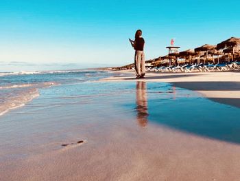 Rear view of man standing on beach