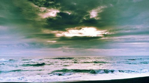 Scenic view of sea against cloudy sky