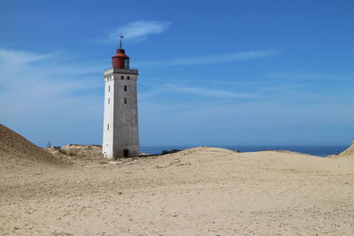 Old lighthouse against blue sky