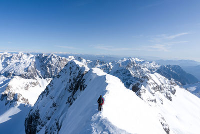 A man walking in a beautiful mountain ridge