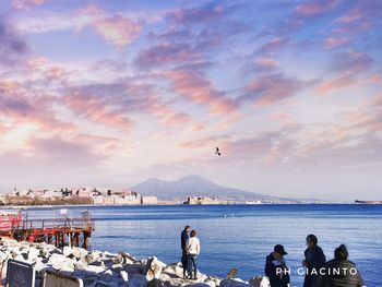 People on beach against sky