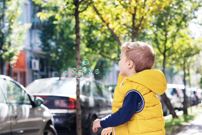 Side view of boy in car