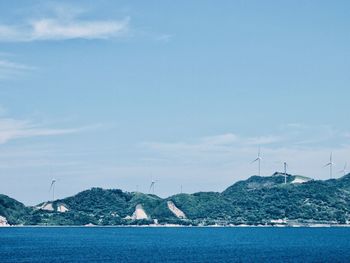 Windmills - power in nature in the bay inlet of the ocean in japan.