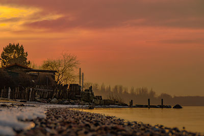 Scenic view of sea against orange sky