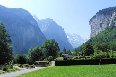 Scenic view of trees and mountains against sky