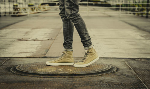 Low section of man standing on street