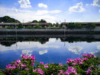 Scenic view of lake by building against sky