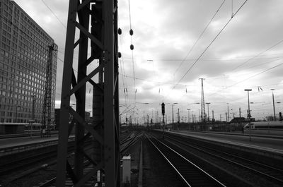 Railroad tracks in city against sky