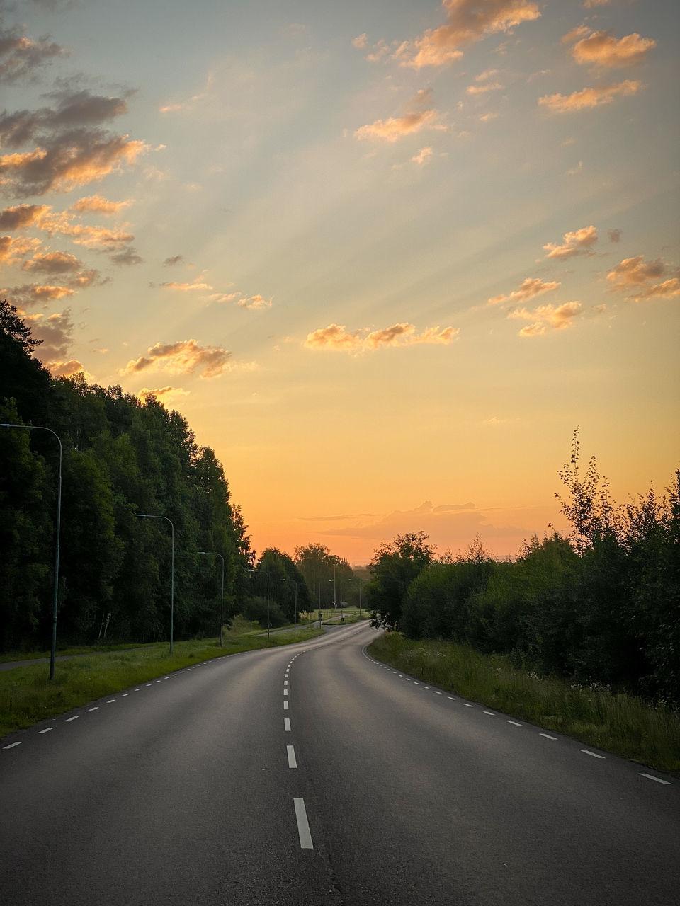 ROAD AGAINST SKY DURING SUNSET