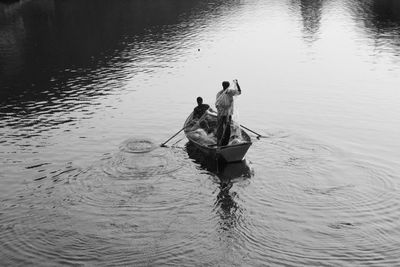 High angle view of men on boat in lake