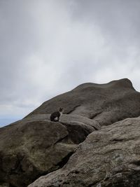 Low angle view of rock formation against sky