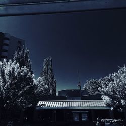 Low angle view of buildings against sky at night