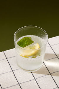 Glass of water on a green background