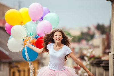 Portrait of a smiling young woman with balloons