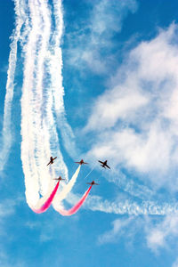 Low angle view of airplane flying against sky