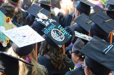 Rear view of graduates wearing hat during event