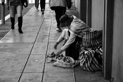 Low section of woman walking on street