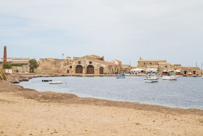 Buildings at beach against sky