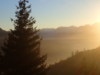 Scenic view of mountains against sky at sunset