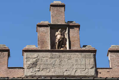 Low angle view of statue against blue sky