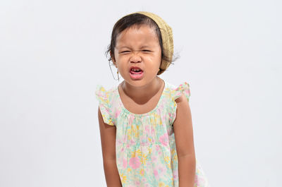 Happy girl standing against white background