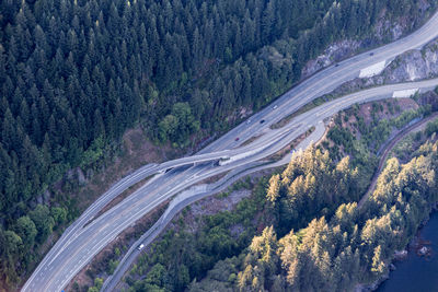 High angle view of highway amidst trees in forest