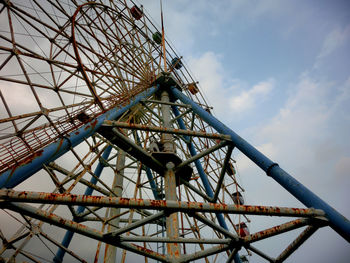 Low angle view of ferris wheel against sky