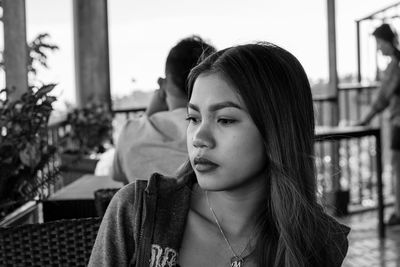 Portrait of a young woman looking away