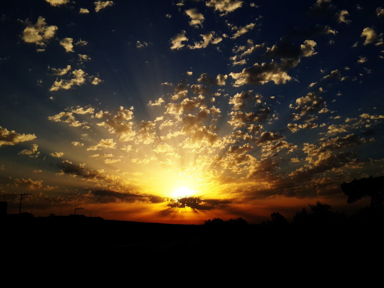 sunset, silhouette, beauty in nature, scenics, sky, tranquil scene, sun, tranquility, orange color, tree, nature, idyllic, cloud - sky, sunlight, landscape, cloud, outdoors, no people, sunbeam, dramatic sky