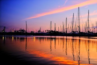 Sailboats in marina at sunset