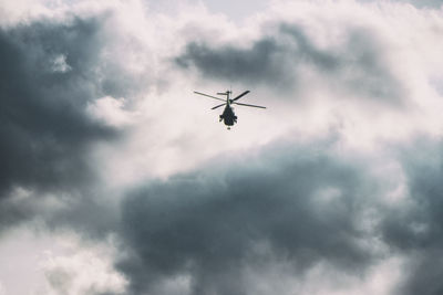 Low angle view of helicopter flying in sky