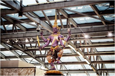 Low angle view of statue against ceiling